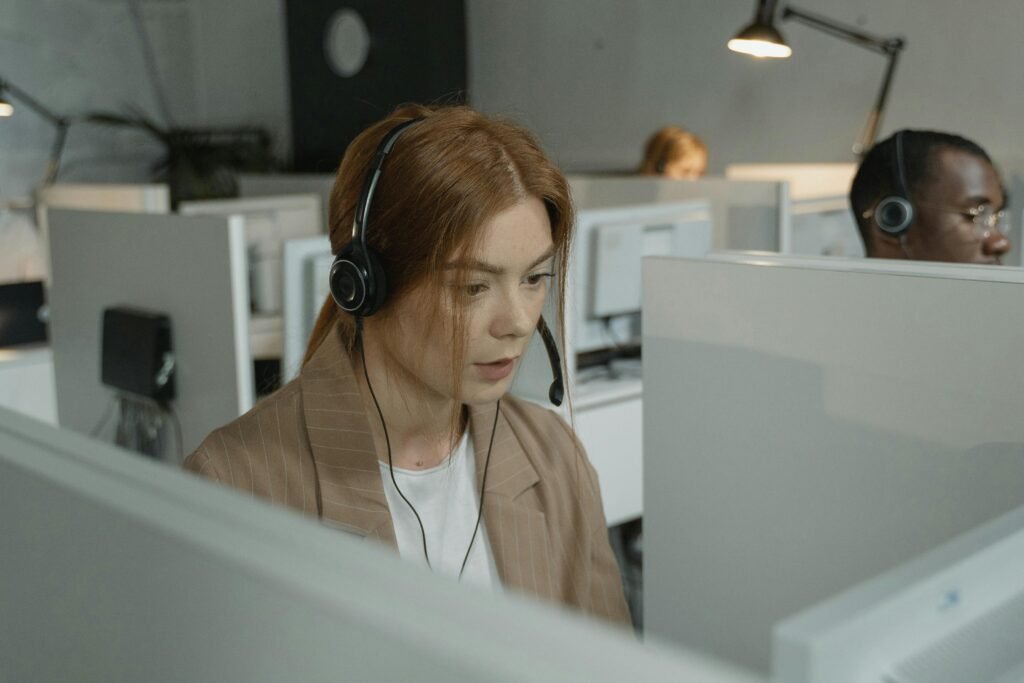 Call center agents working efficiently with headsets in a modern office setting.